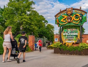 Entrance to Drayton Manor Zoo with visitors walking towards it.